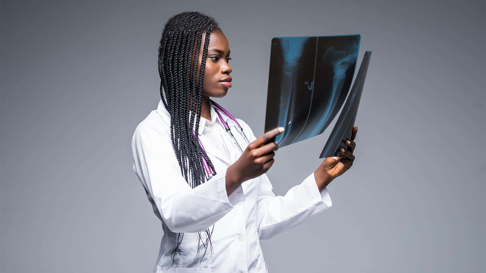 Radiant Young Black Woman with X-Rays in a Medical Setting Wallpaper
