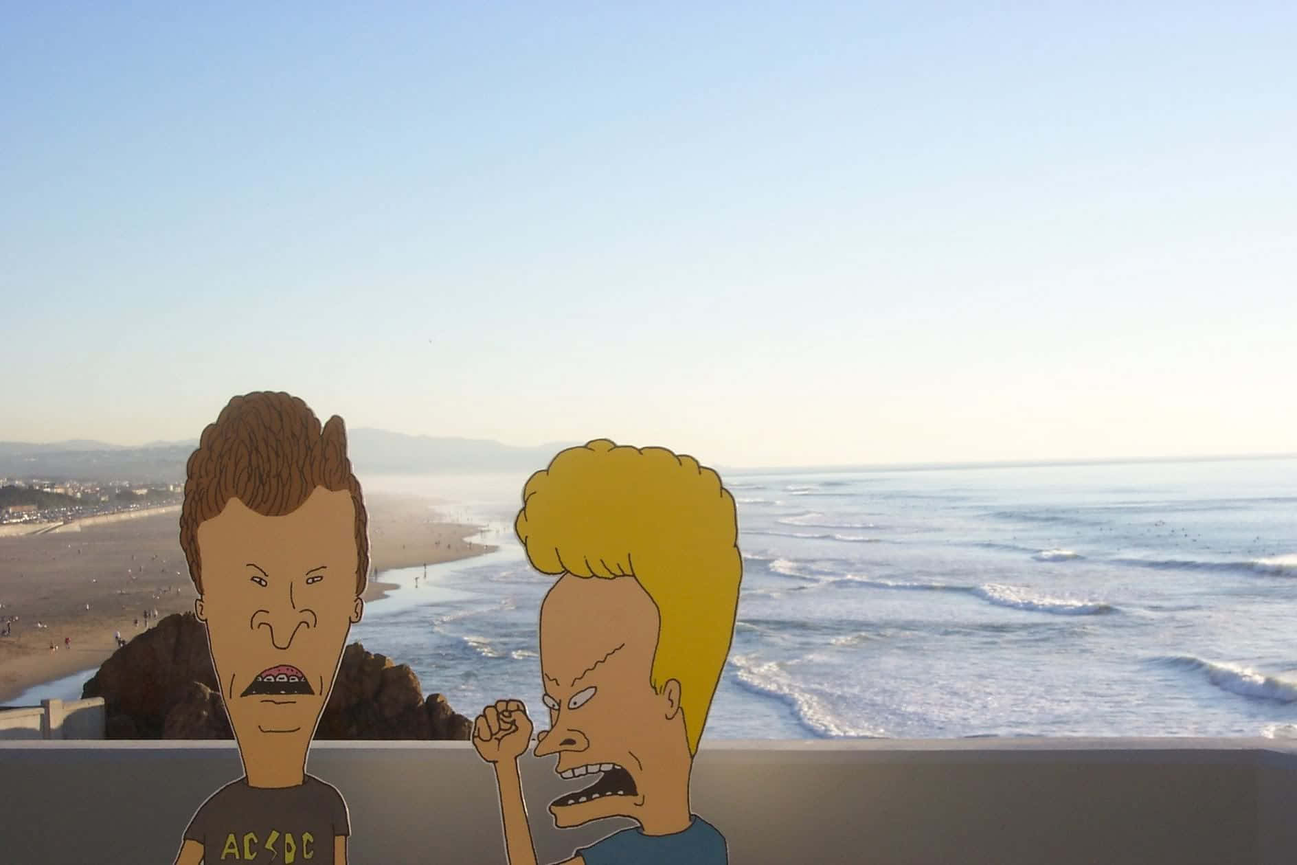 Two Cartoon Characters Standing On A Balcony Overlooking The Ocean