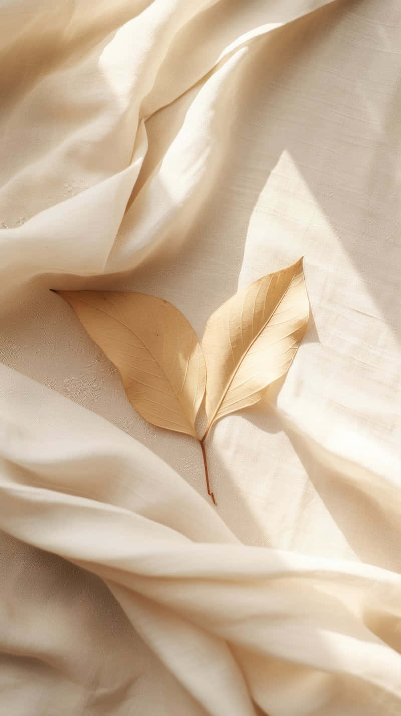 Beige Leaf On Textured Fabric.jpg Wallpaper
