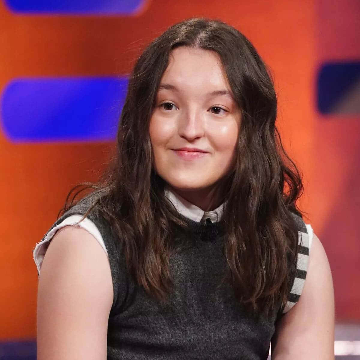 Bella Ramsey Smiling During Interview Wallpaper