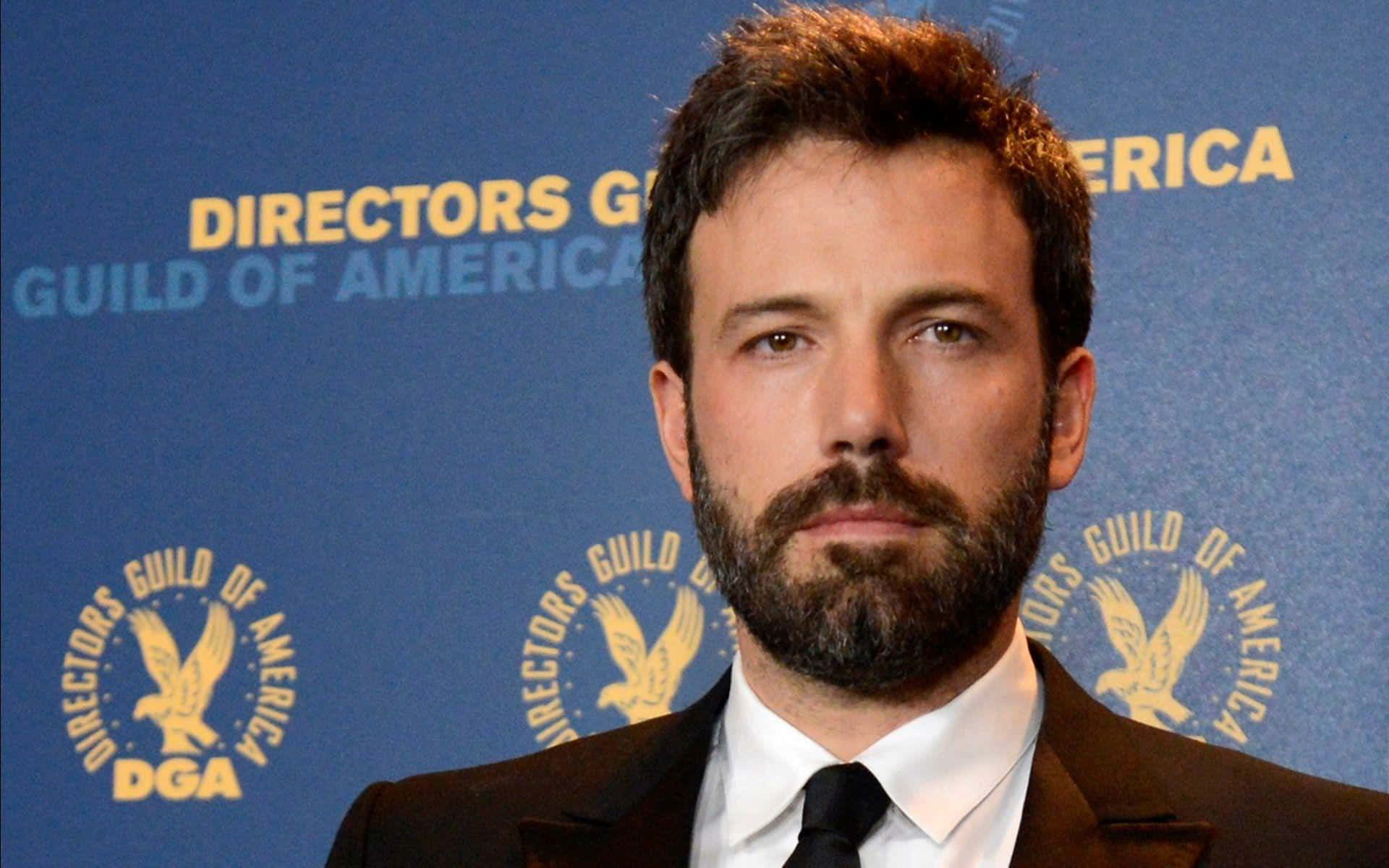 Ben Affleck wearing a brown suit and white shirt