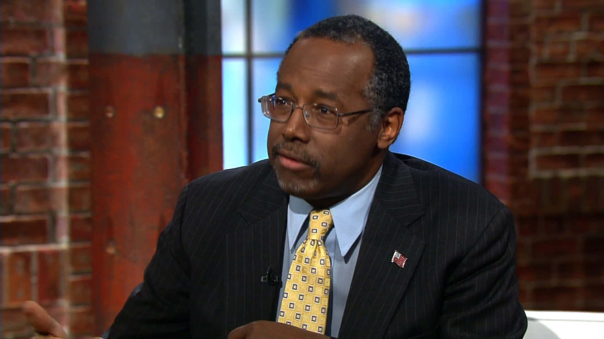 "Dr. Ben Carson attentively listening at a discussion event" Wallpaper