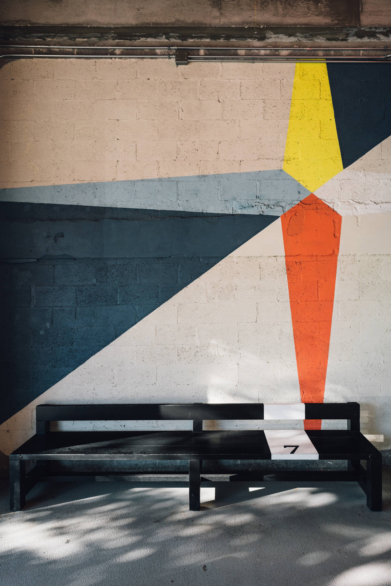 Bench Against Geometric Wall Wallpaper