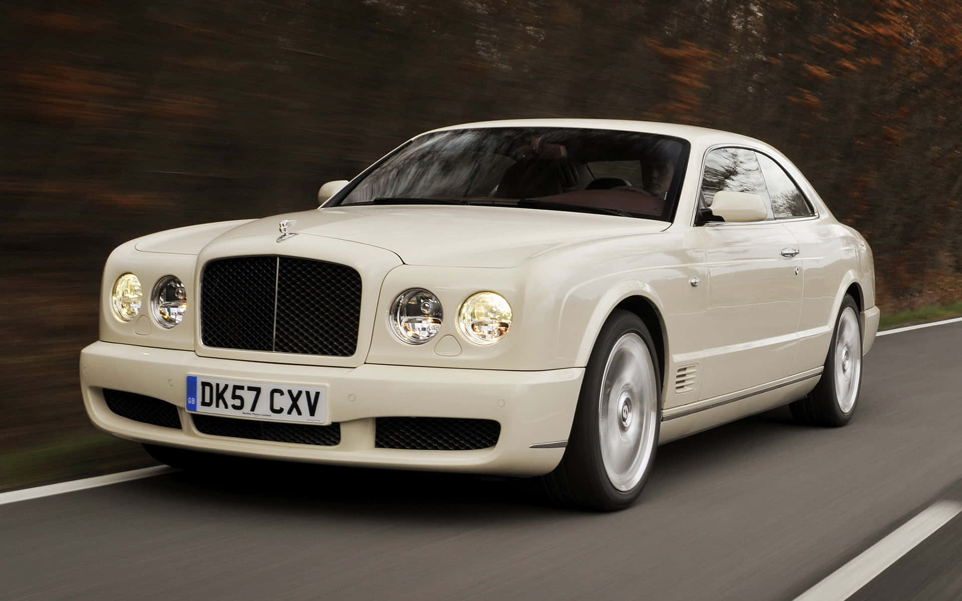 A Sleek Bentley Brooklands on a Scenic Road Wallpaper