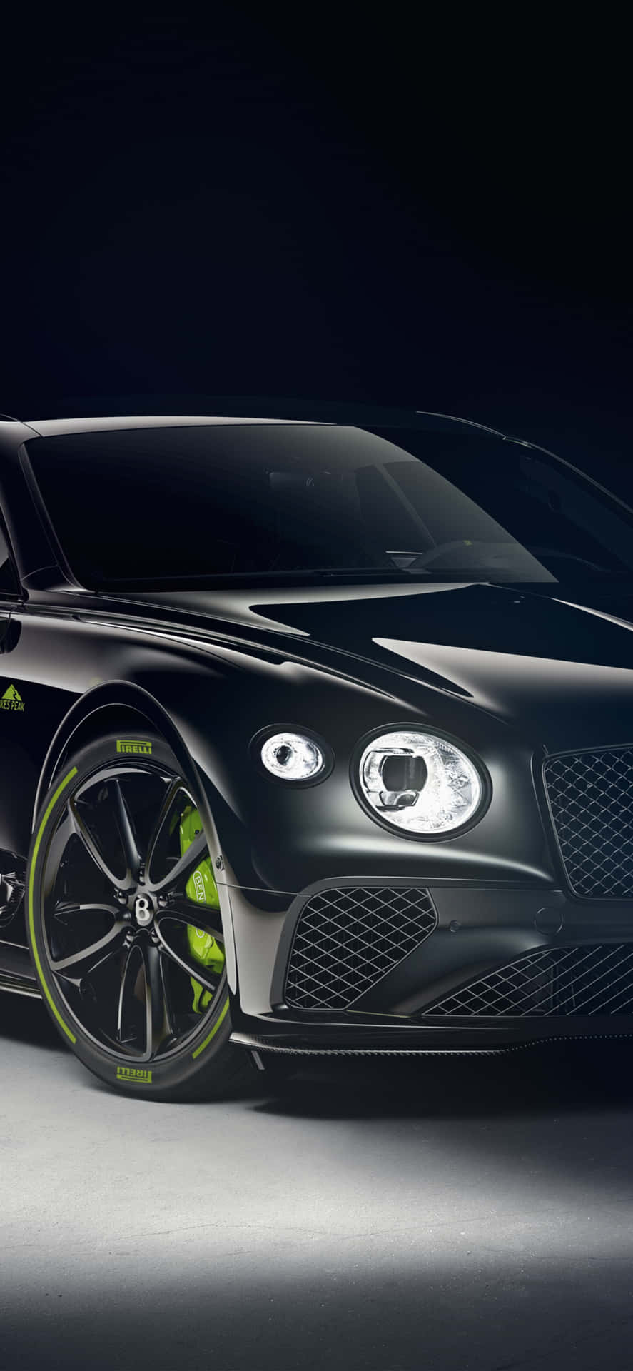Sleek Bentley Continental GT Basks in the City Nightlife Wallpaper