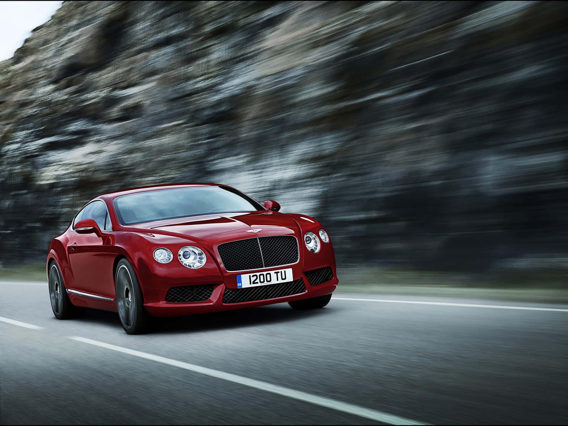 Caption: A magnificent Bentley Continental GT in a captivating setting. Wallpaper