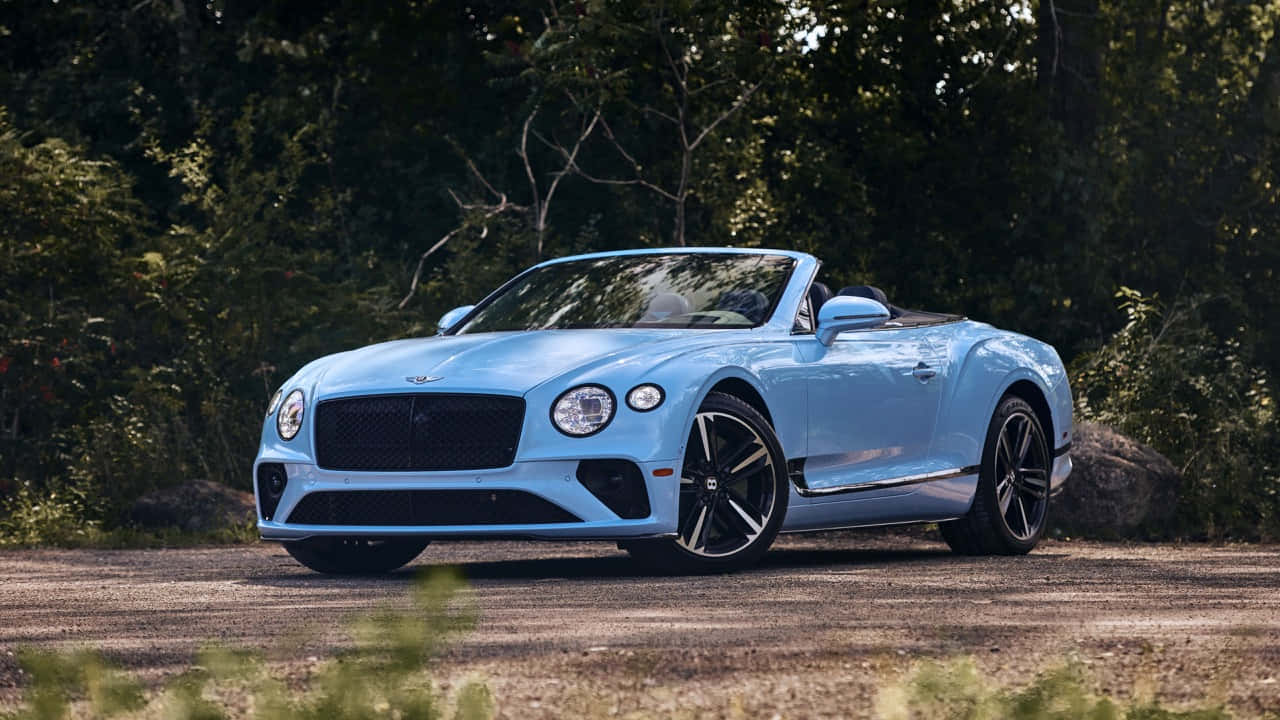 Caption: Majestic Bentley Continental GT Convertible in an Open Road Wallpaper