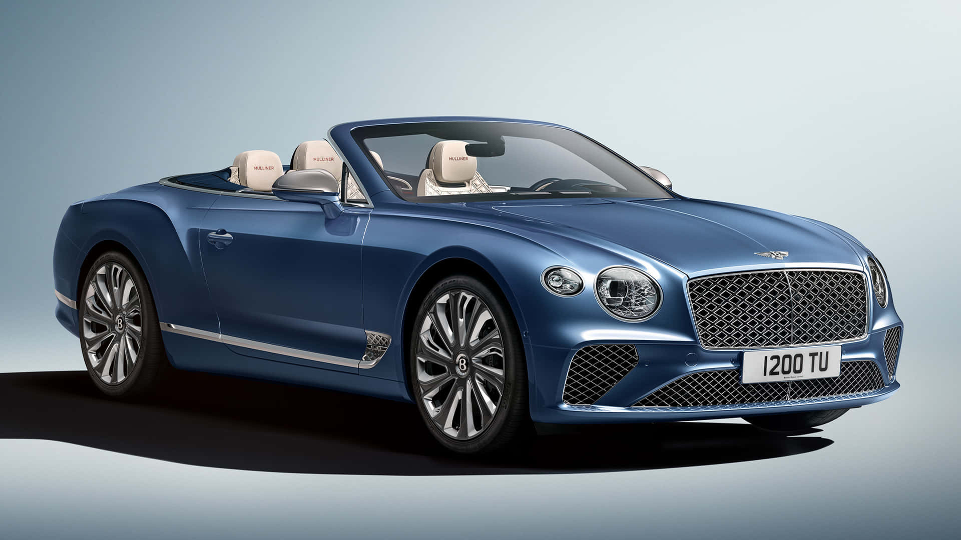 Sleek Bentley Continental GT Convertible cruising on the street Wallpaper