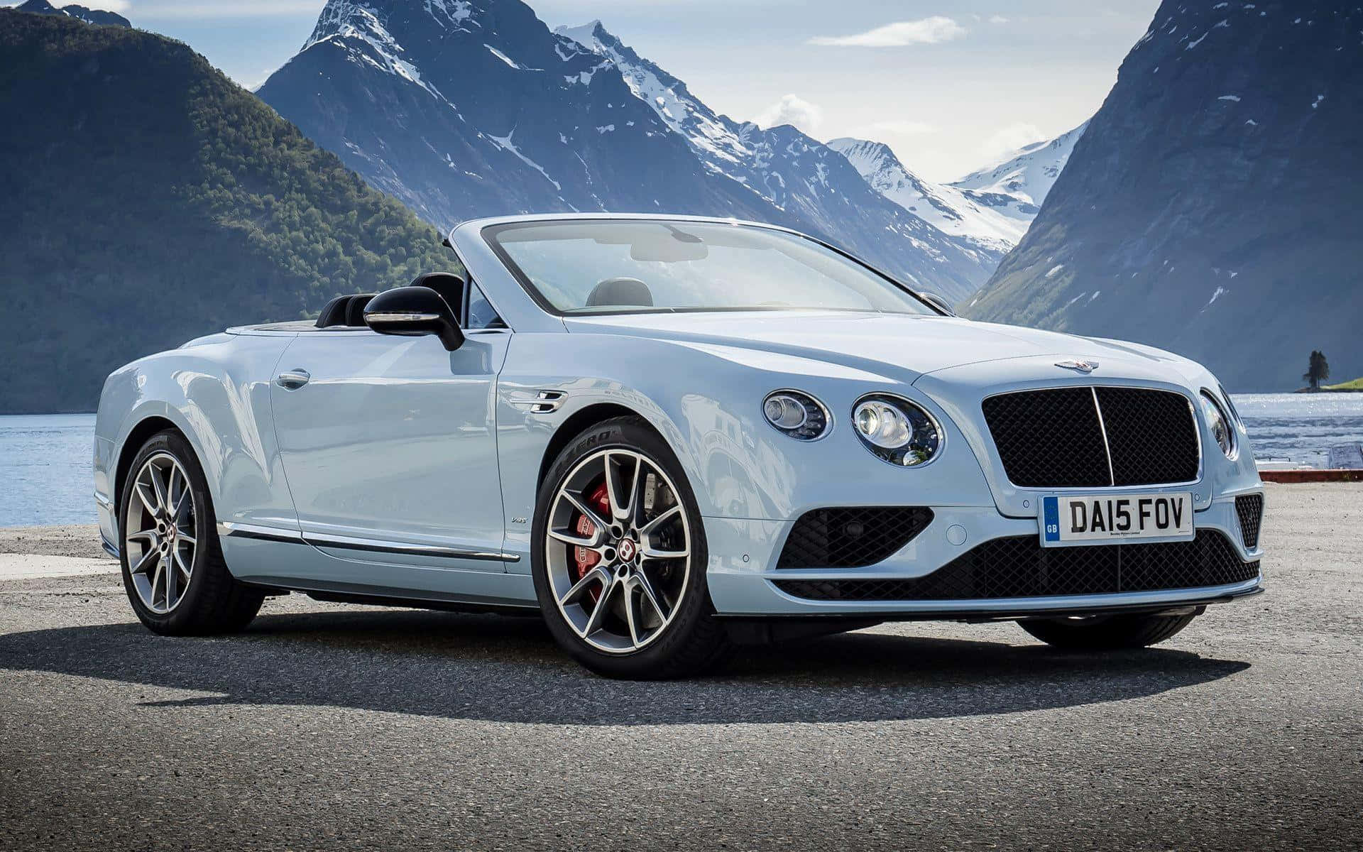 Elegant Bentley Continental GT Convertible cruising down the road Wallpaper