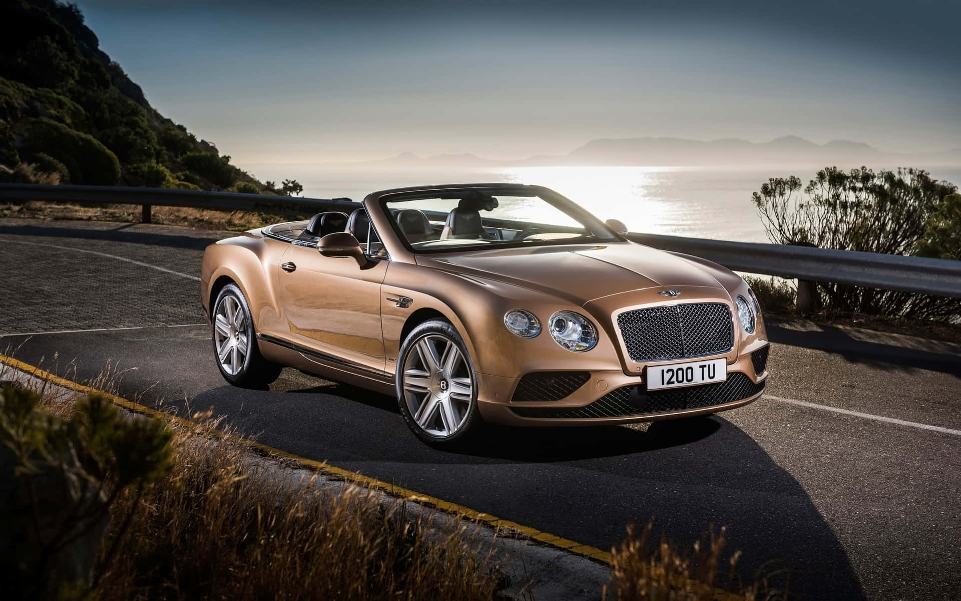 Luxurious Bentley Continental GT Convertible Cruising Down the Road Wallpaper