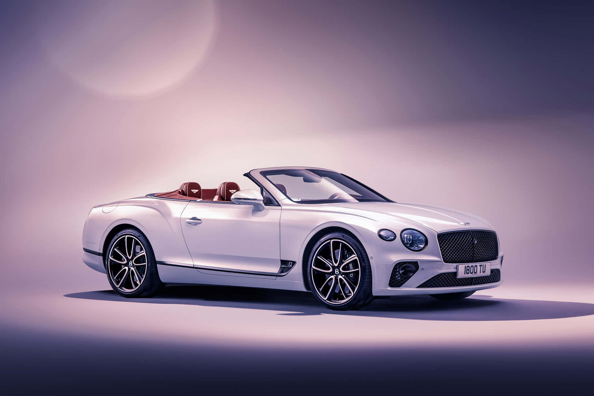 Caption: Stunning Bentley Continental GT Convertible Cruising in Style Wallpaper