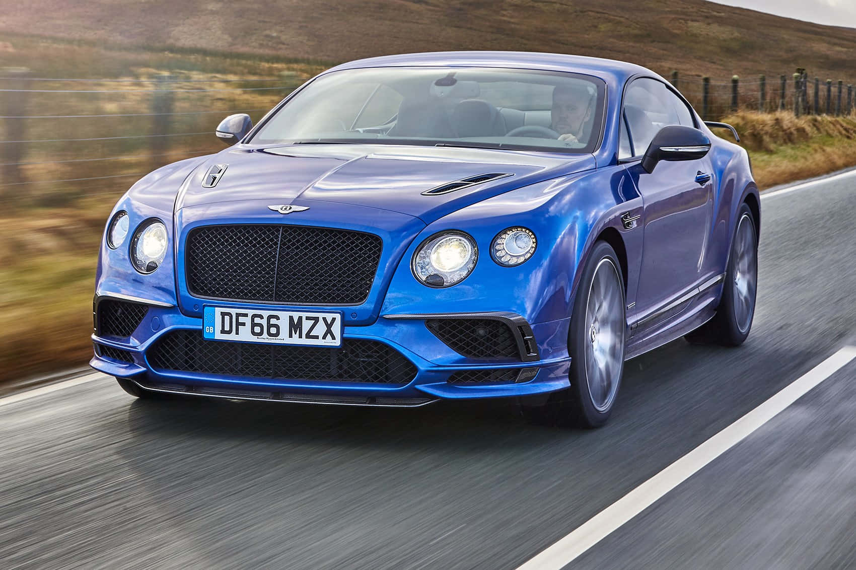 Bentley Continental Supersports in action on a picturesque road Wallpaper