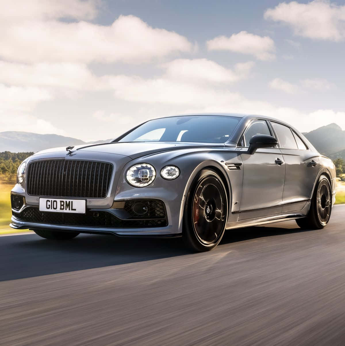 Elegant Bentley Flying Spur Cruising on the Road Wallpaper