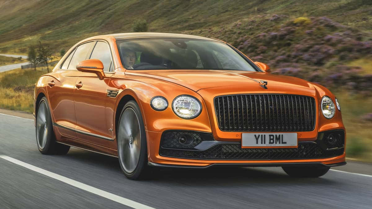 Sleek and Luxurious Bentley Flying Spur in Motion Wallpaper
