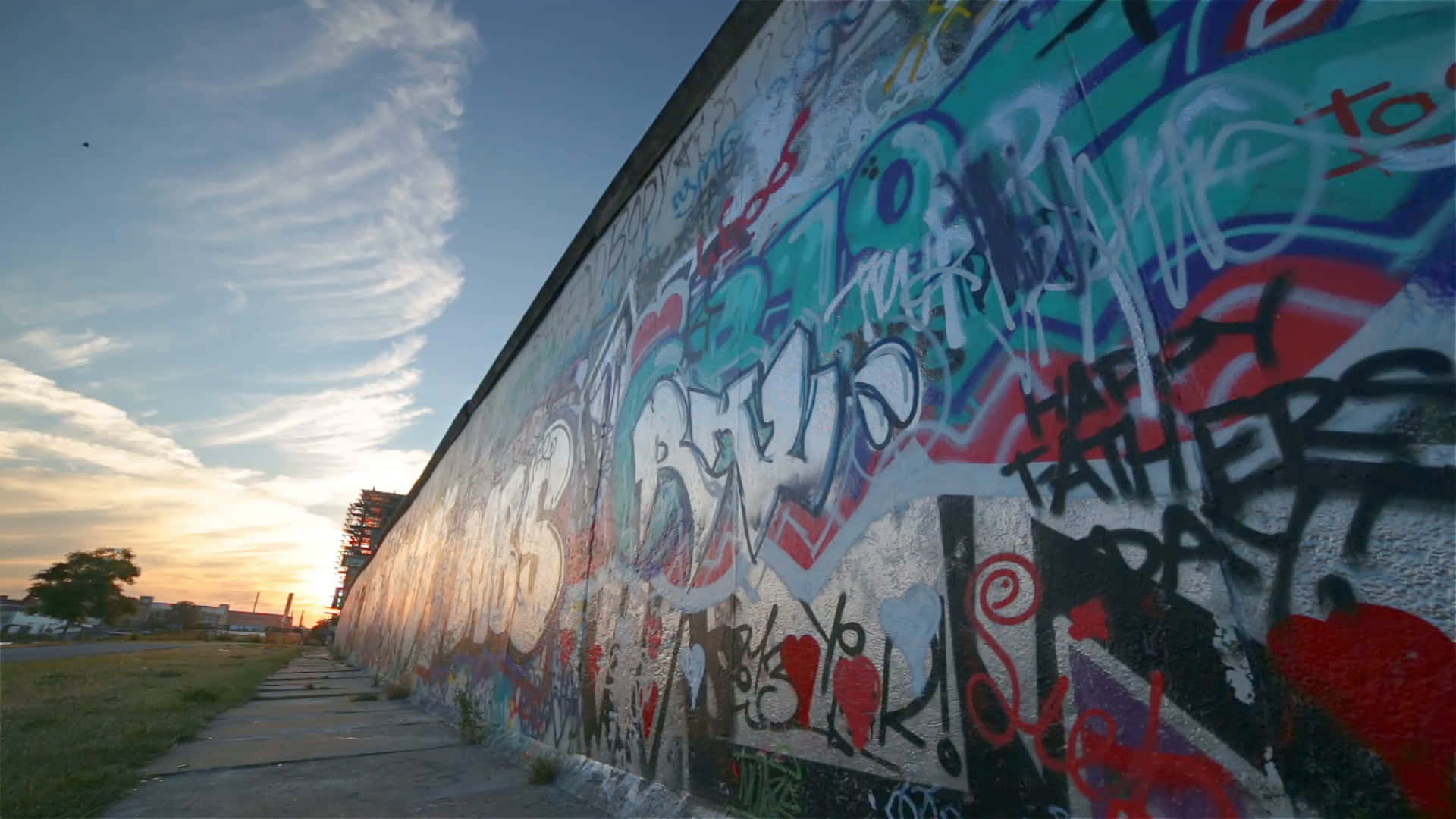Berlin Wall Graffiti During Sunset Background