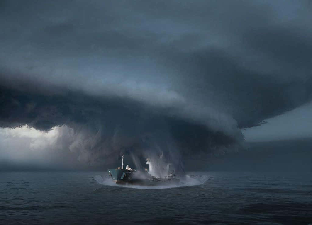 A Ship Is In The Ocean With A Storm Cloud Over It