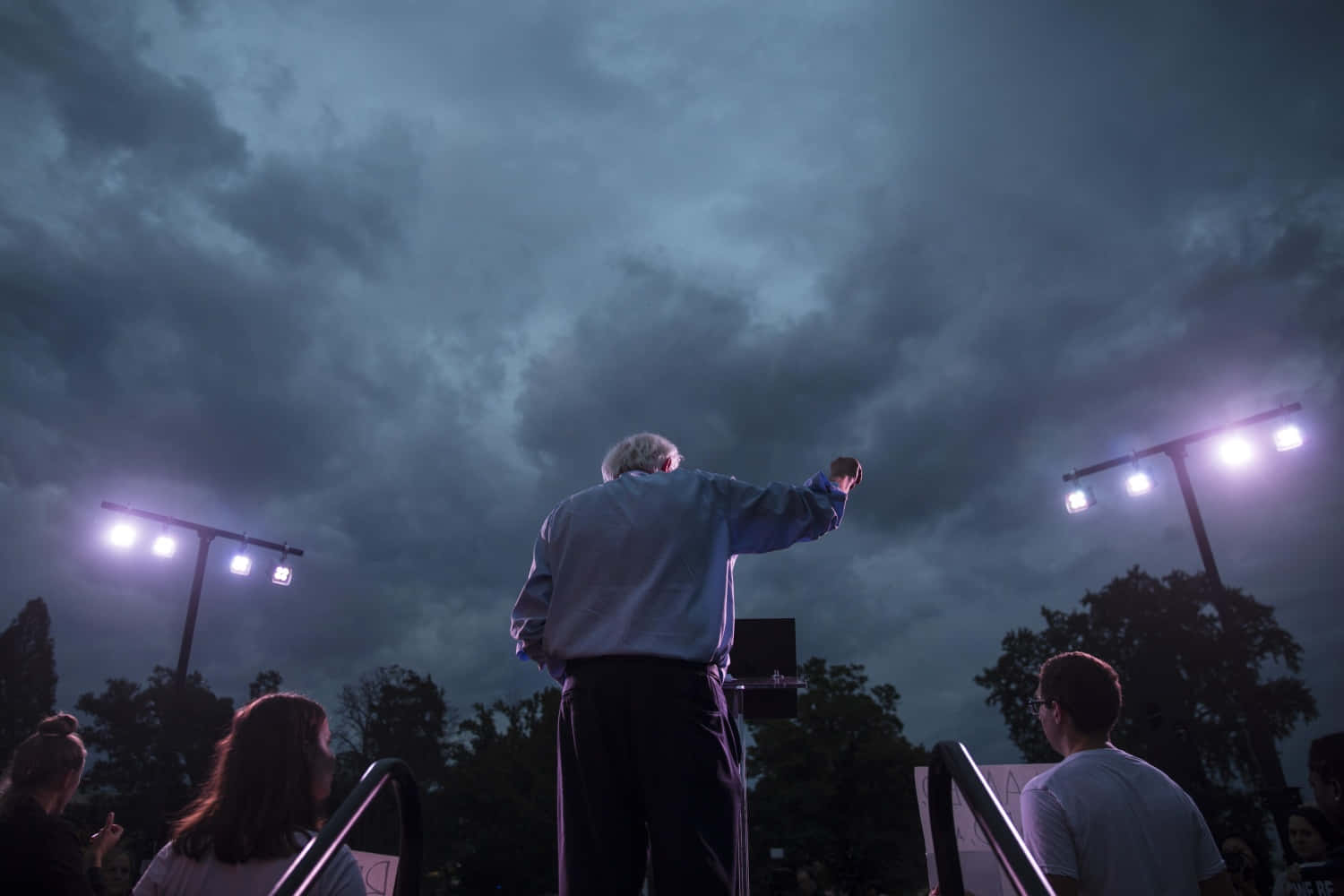 Bernie Sanders Speaking Under Stormy Skies Wallpaper