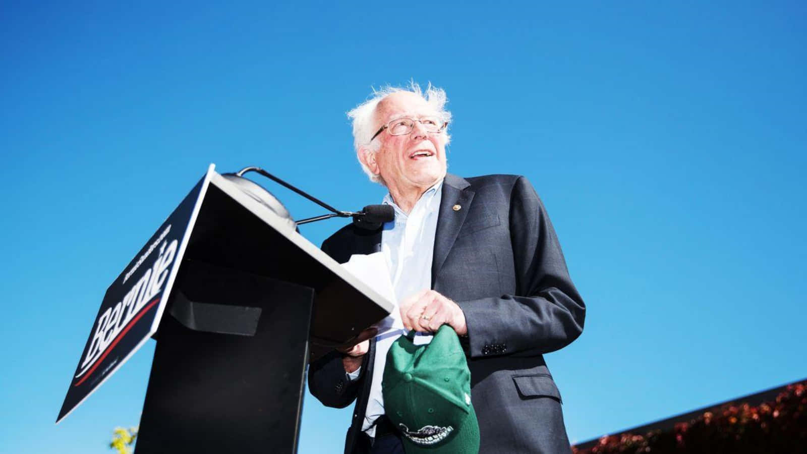 Bernie Sanders Speakingat Podium Outdoors Wallpaper