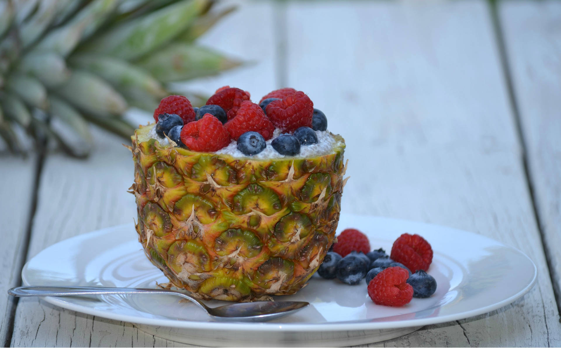 Sweet and juicy pineapples topped with fresh berries Wallpaper
