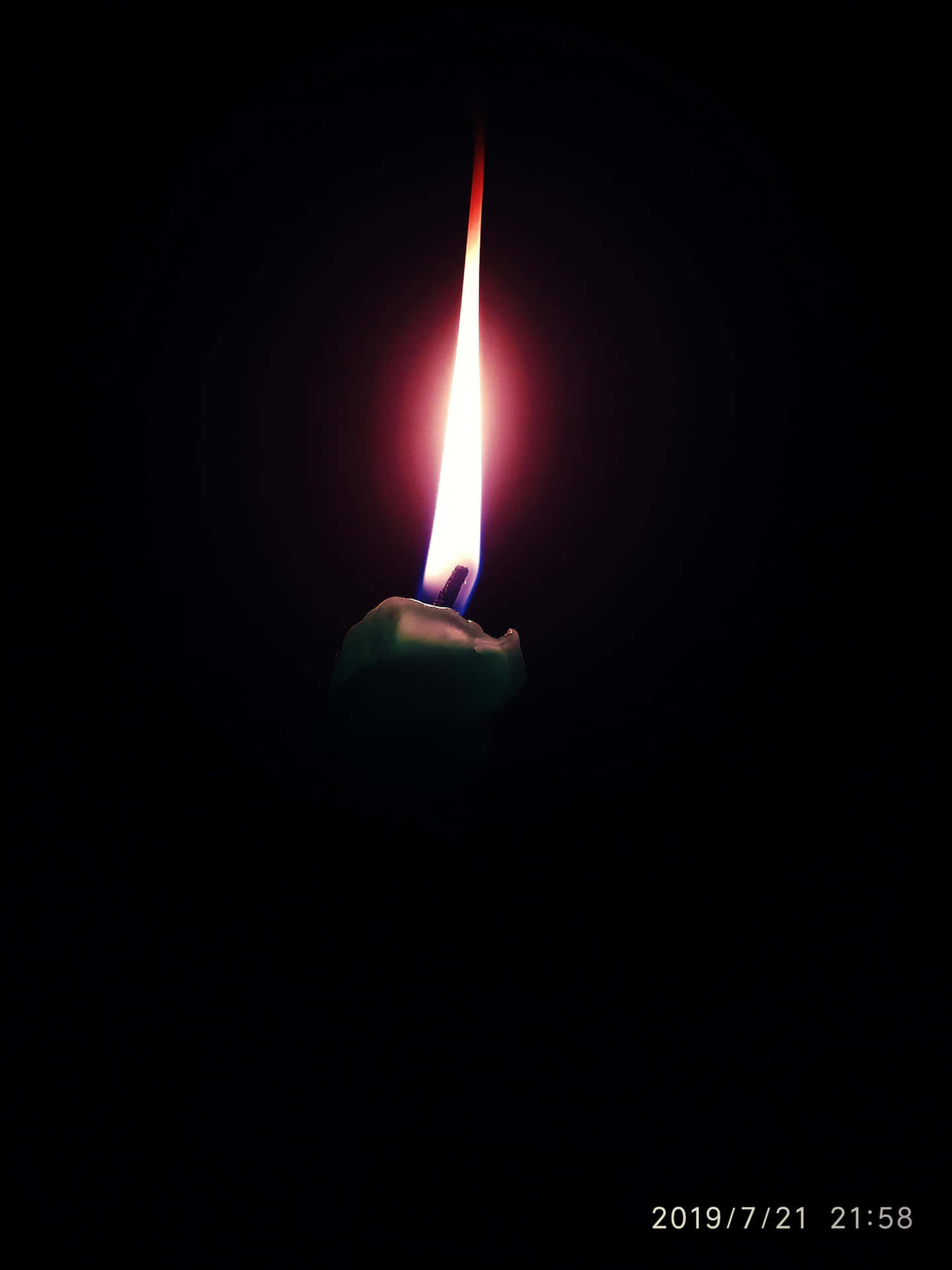 A Candle Lit In The Dark With A Black Background Wallpaper