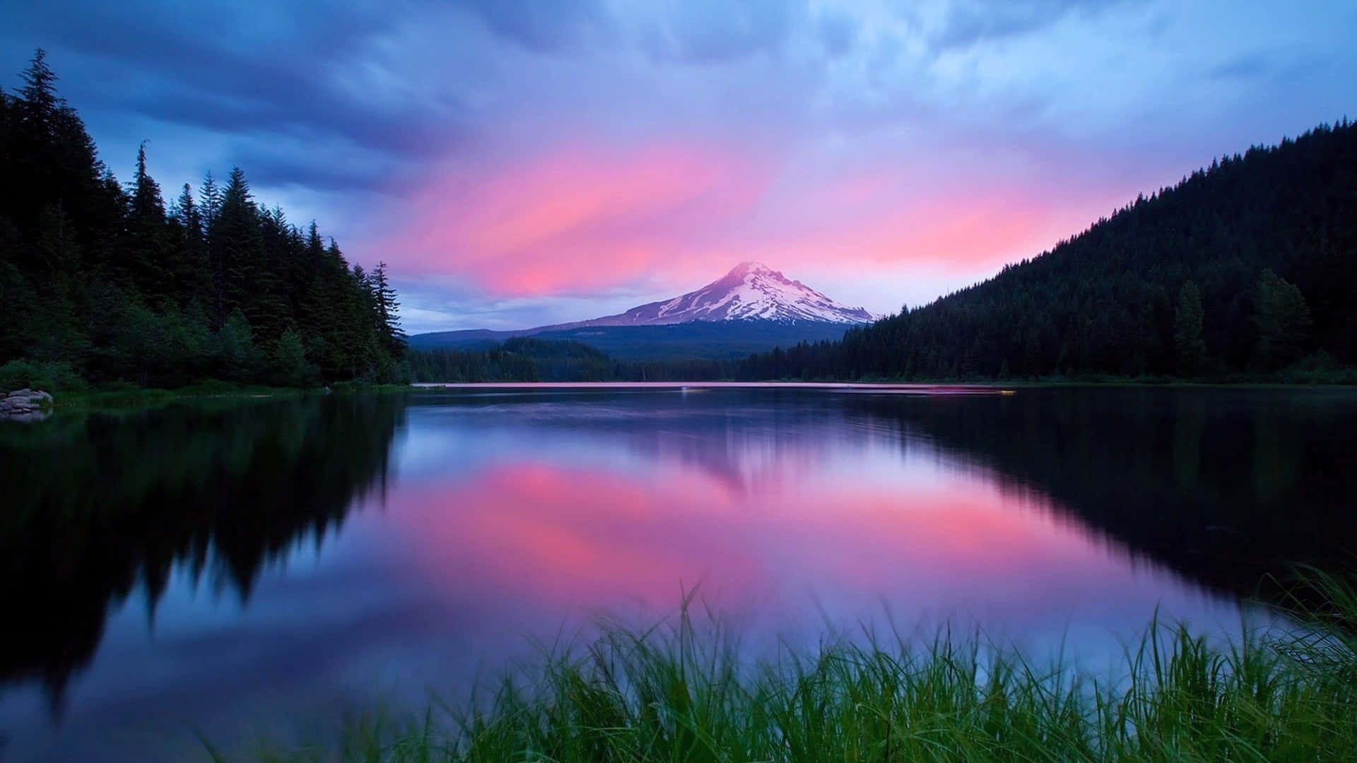 a mountain is reflected in a lake at sunset