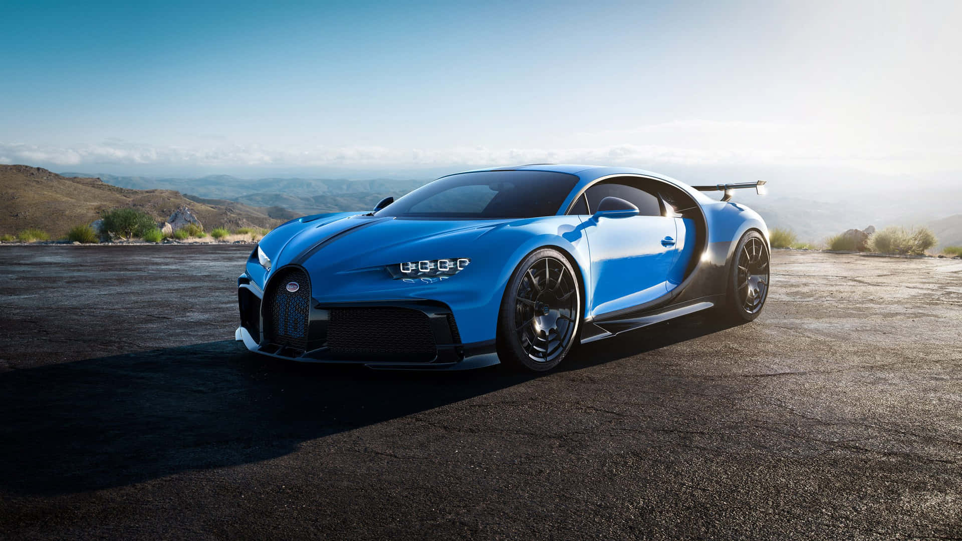 The Blue Bugatti Chiron Is Parked On A Mountain Wallpaper