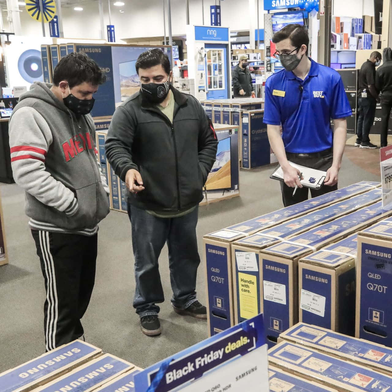 A Group Of People Looking At Boxes In A Store