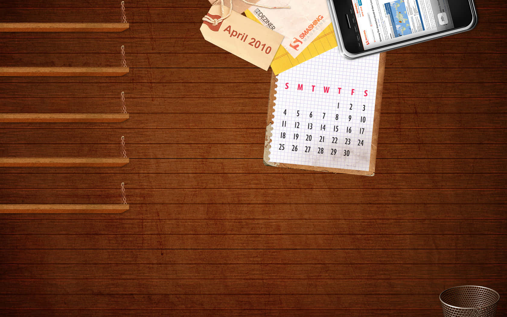 Et skrivebord med en kalender og en telefon.