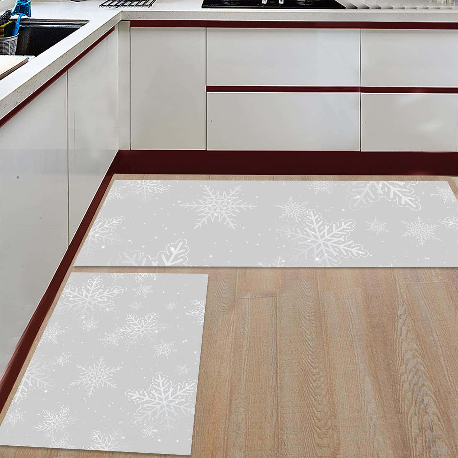 Two Kitchen Mats With Snowflakes On Them