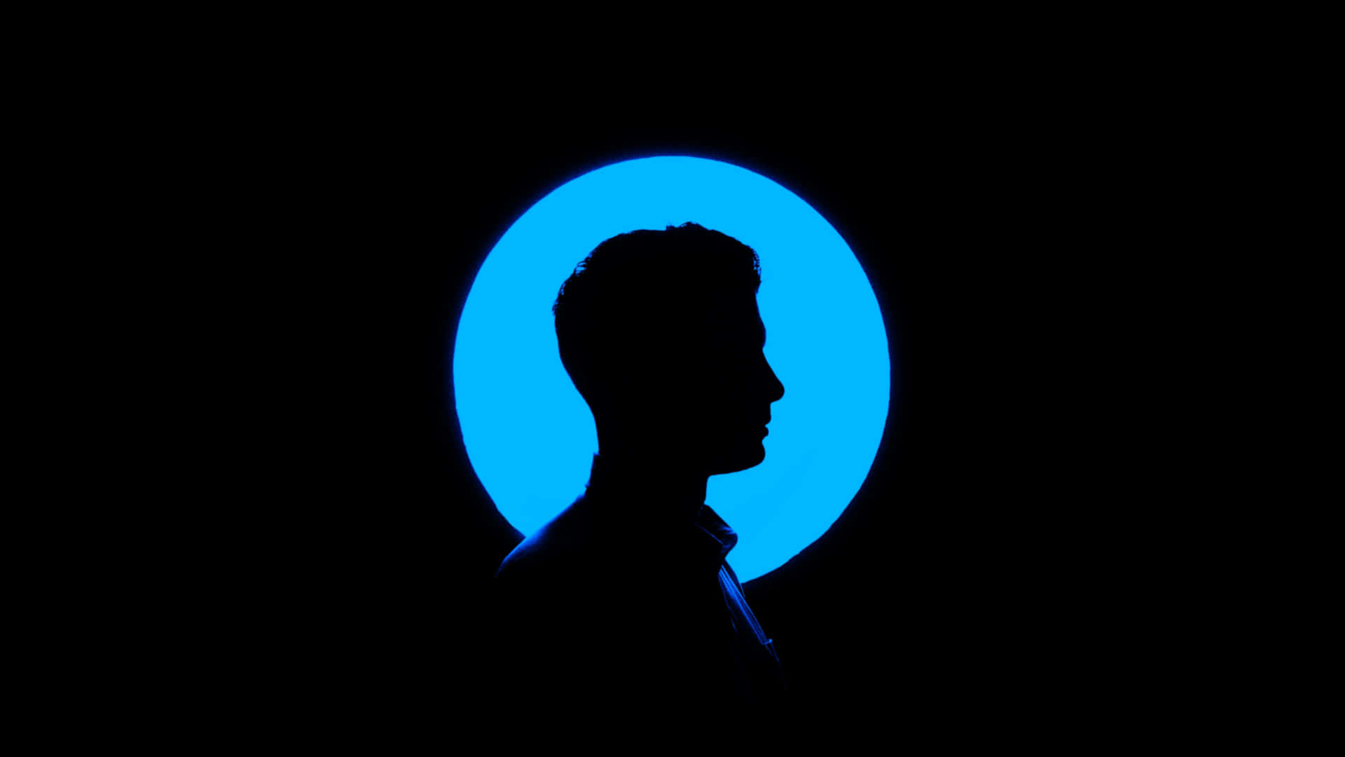 A Silhouette Of A Man In A Blue Circle