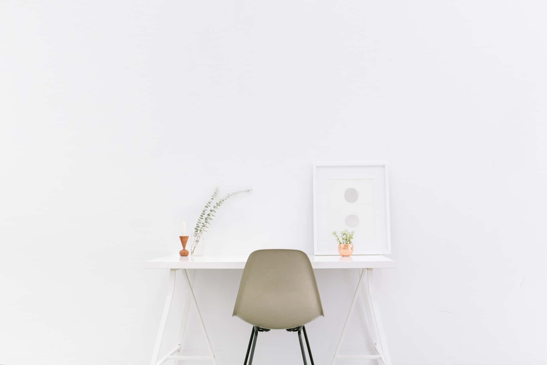A White Desk With A Chair And Plant In The Corner