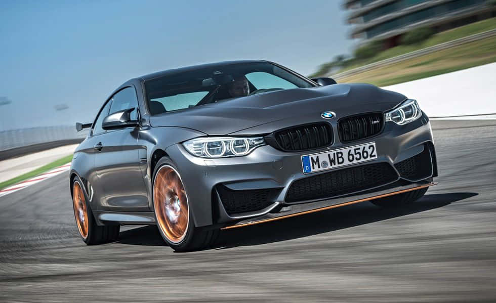 The Bmw M4 Is Driving On A Track