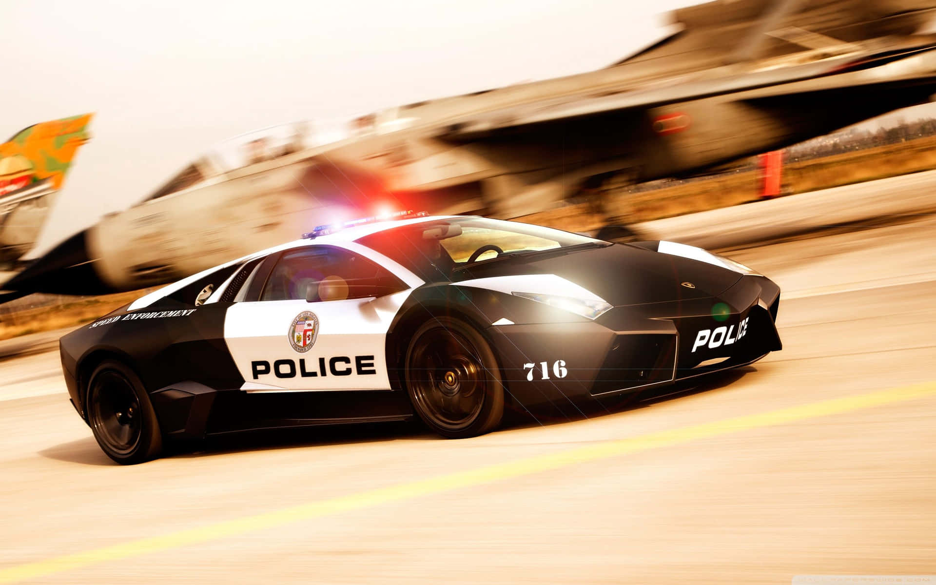 A Police Car Driving Down The Runway With An Airplane In The Background