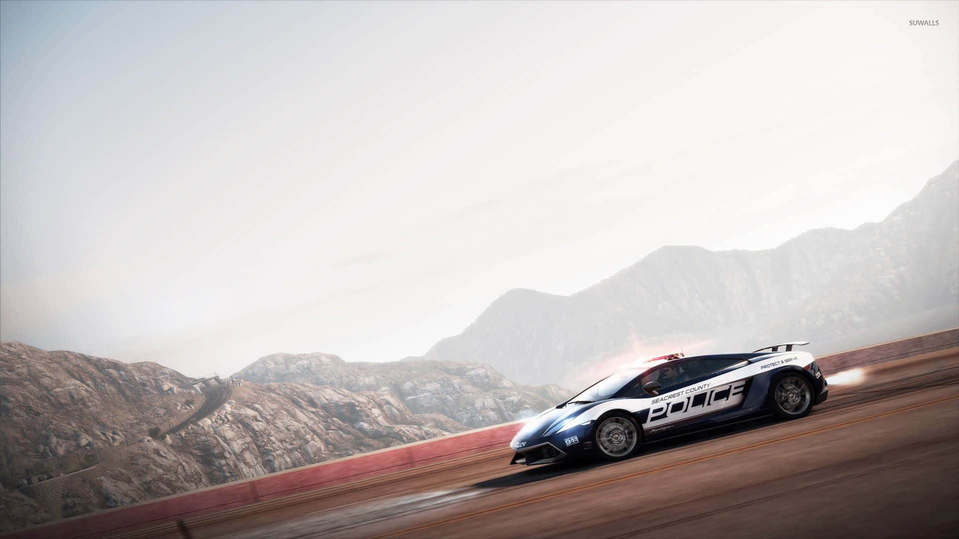 A Police Car Driving On A Track With Mountains In The Background