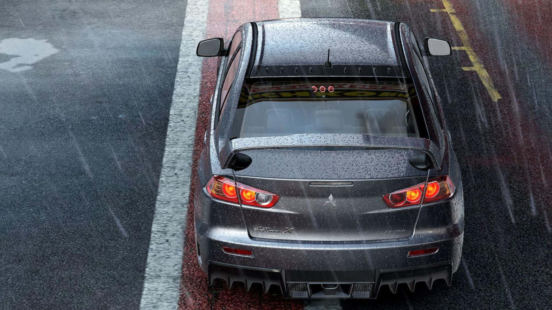 A Car Driving Down A Rainy Road