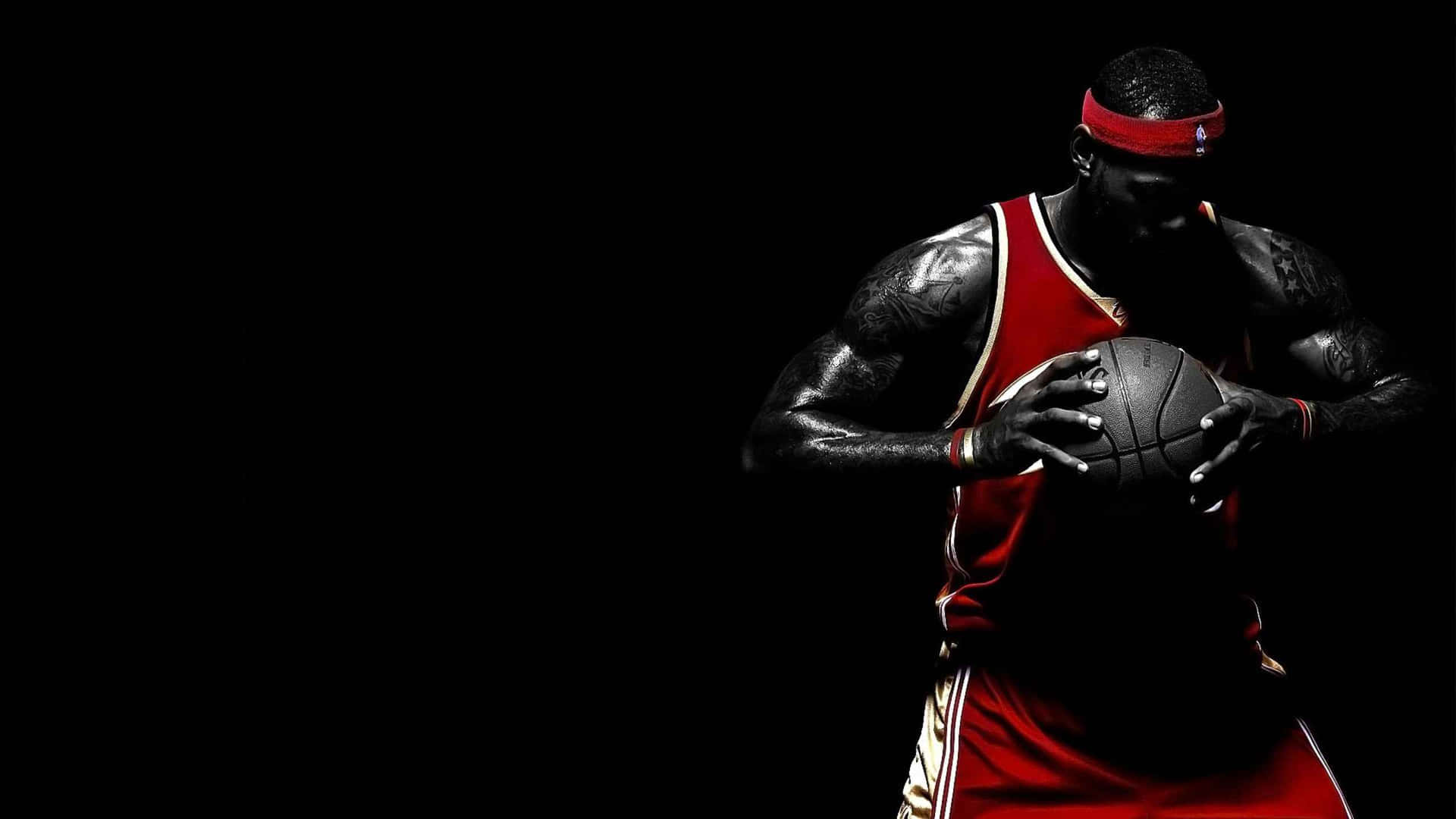 A Basketball Player Holding A Ball In His Hands Wallpaper