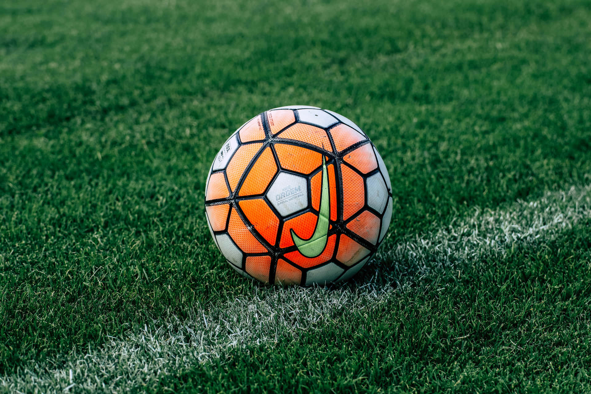 A Soccer Ball On A Green Field Wallpaper