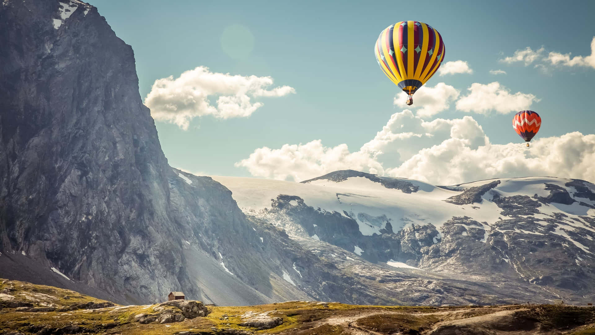 Hot Air Balloons Flying Over Mountains