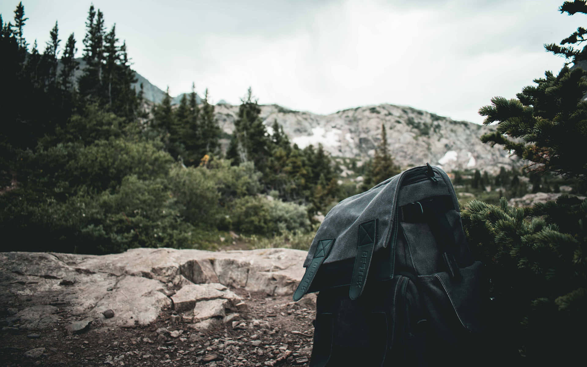 A Black Backpack On A Rocky Trail