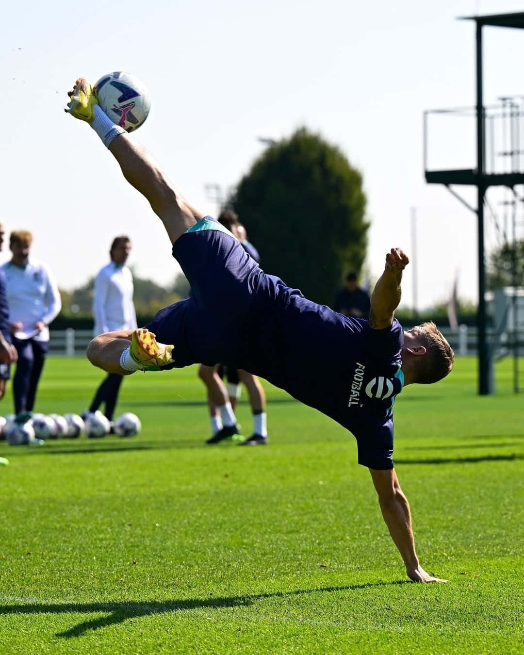 A Man Doing A Flip On A Soccer Ball