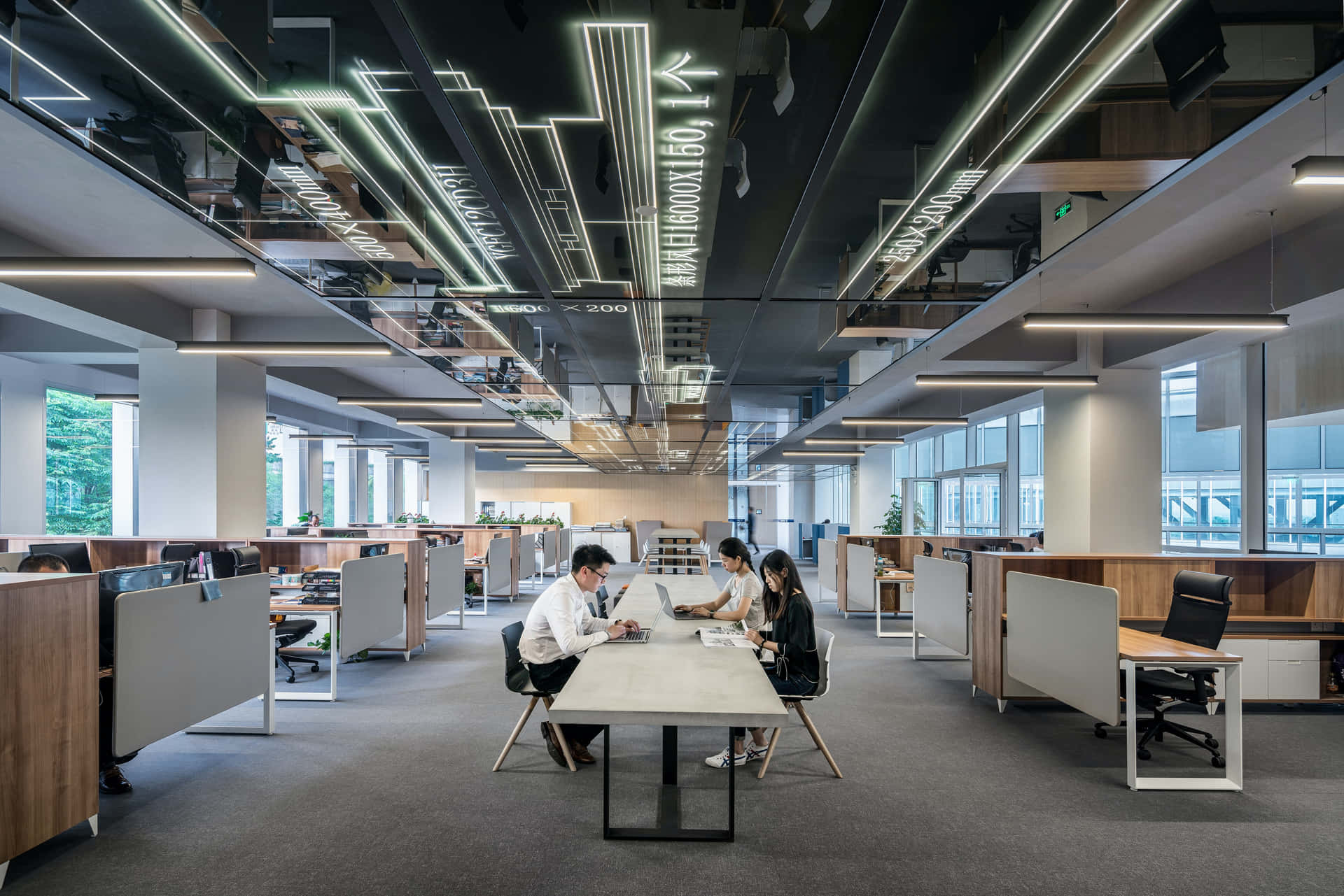 A Large Open Office With People Working At Desks