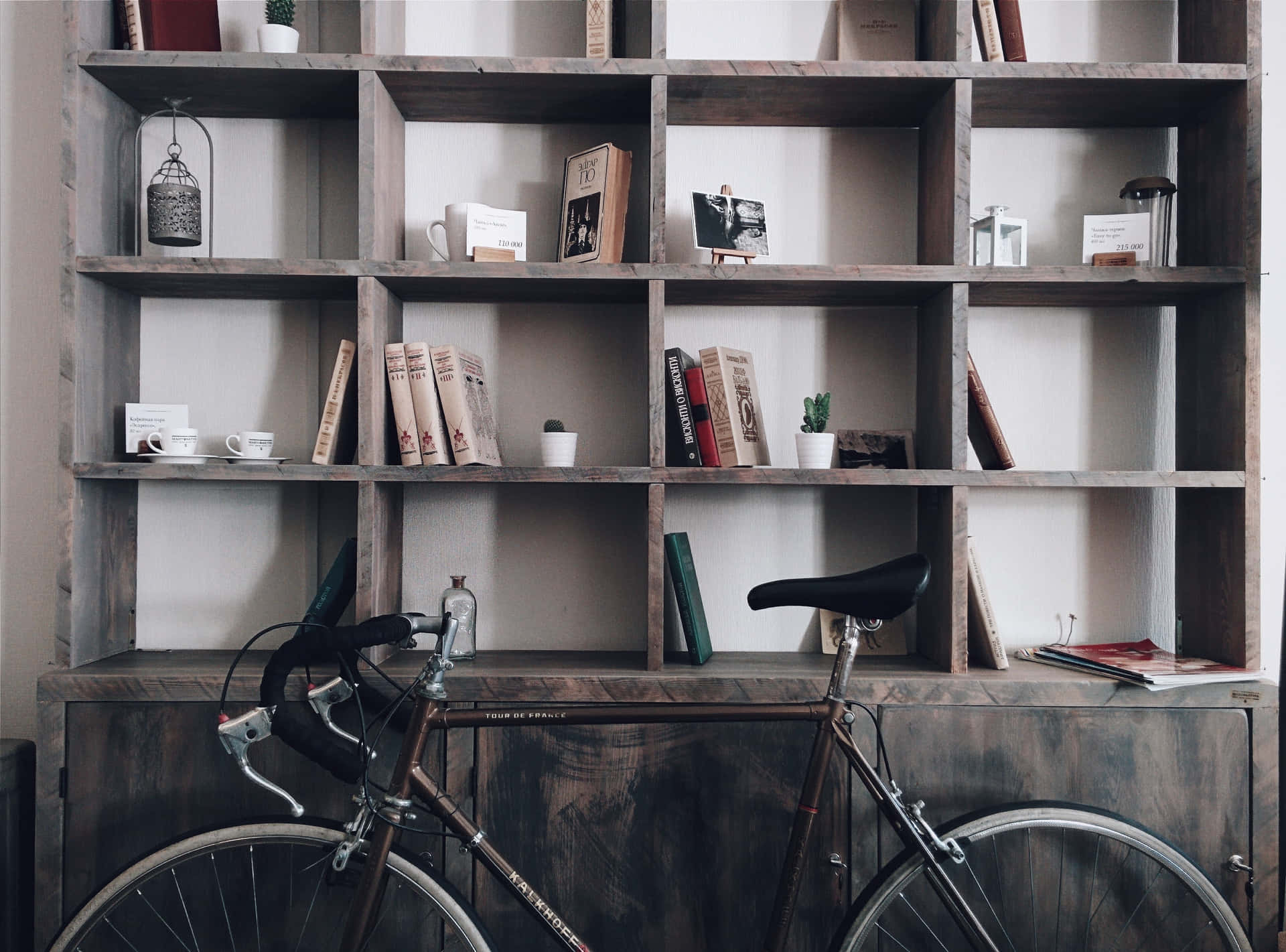 A Bicycle Is Parked In Front Of A Bookcase