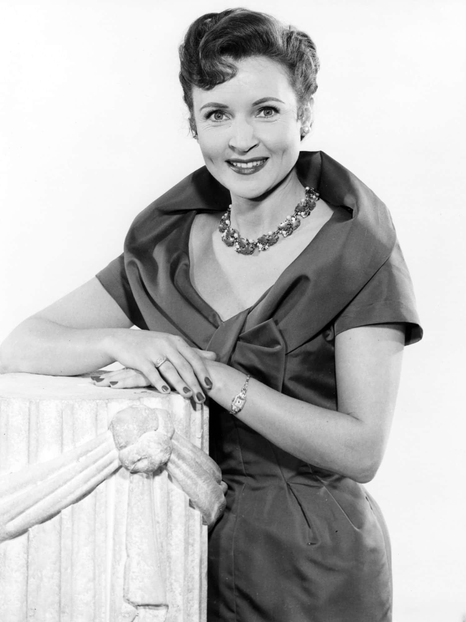 A radiant Betty White smiling and posing in a stylized photoshoot