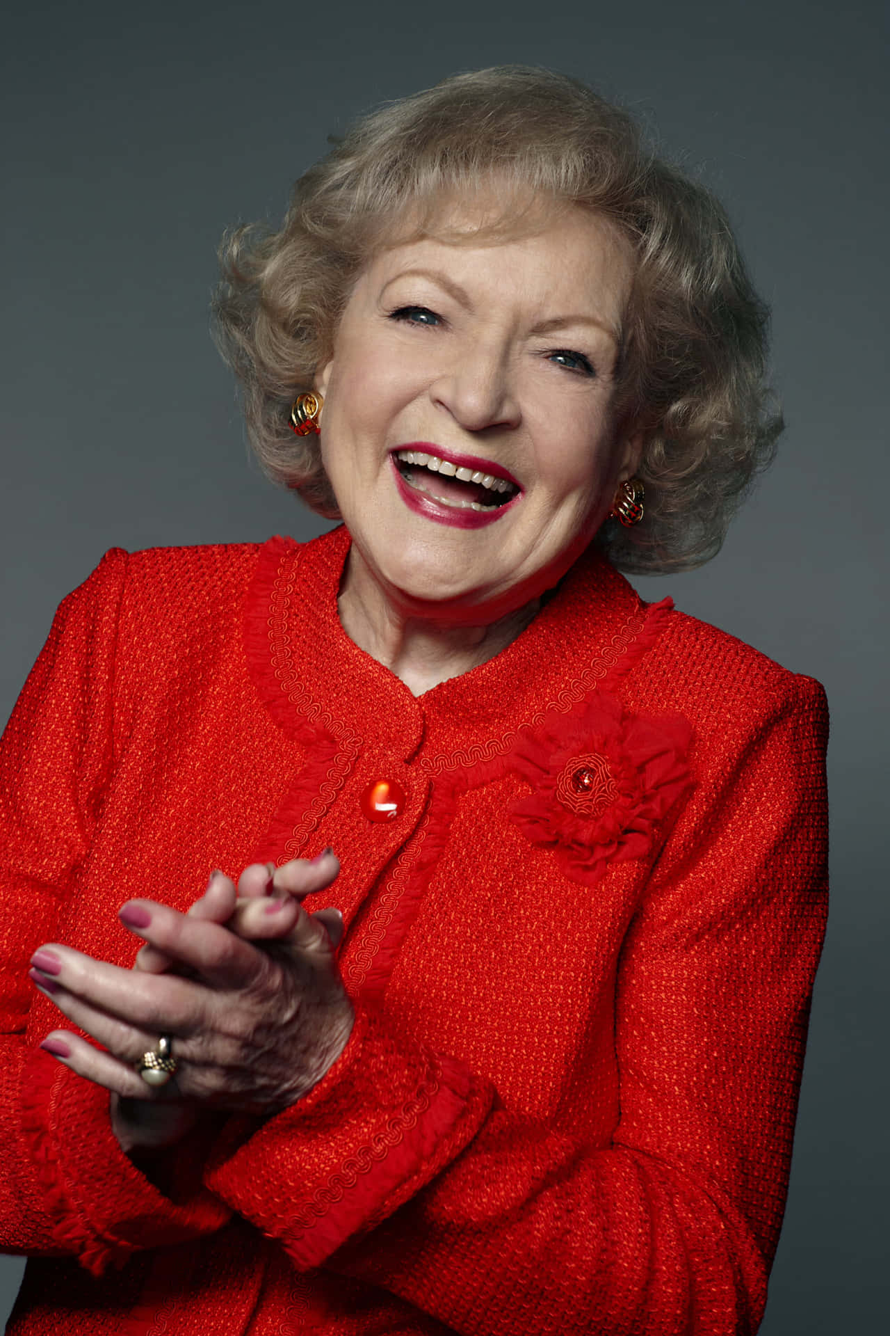 Betty White - A Woman In A Red Jacket Clapping