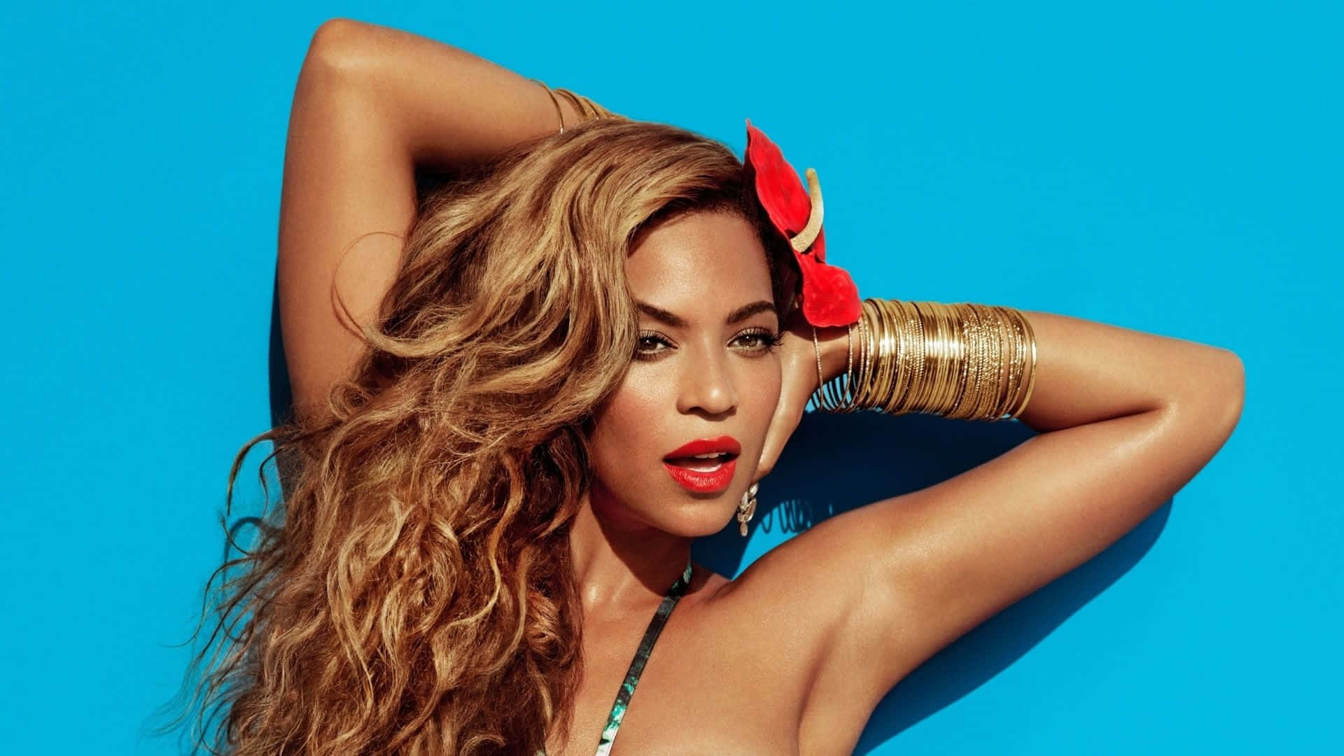 Beyoncé looking fierce in her signature yellow wrap dress.