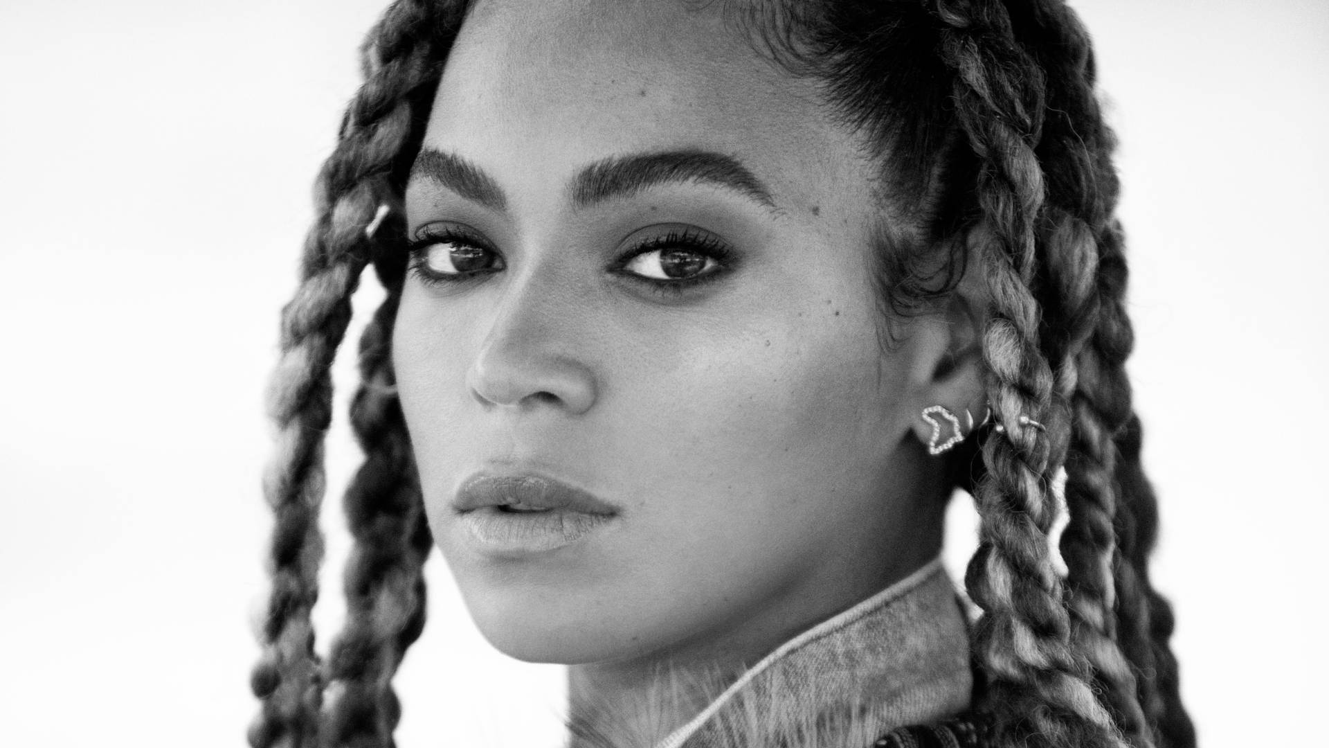 Beyonce wears her signature braids with statement earrings Wallpaper