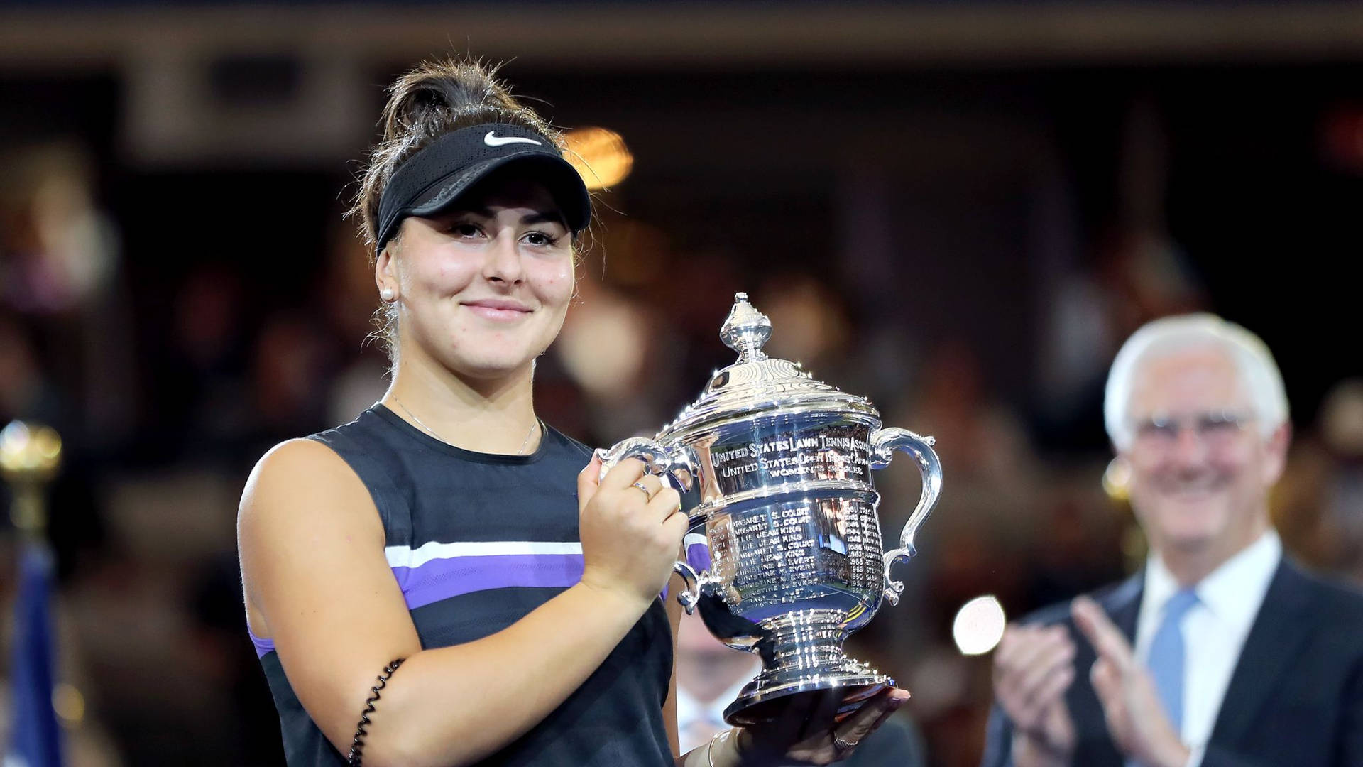 Bianca Andreescu Holding Her Trophy Up Wallpaper