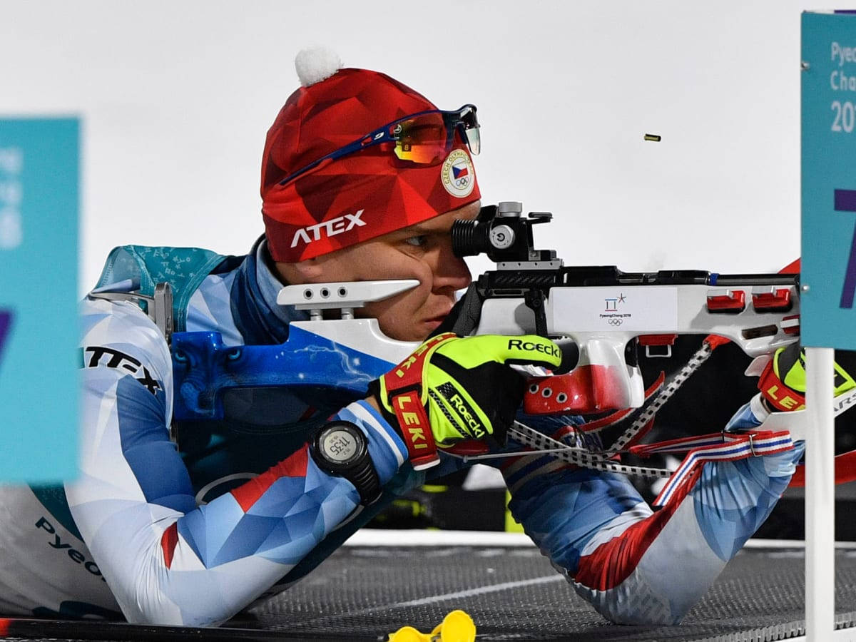 Biathlon Athlete Aiming With Precision Wallpaper