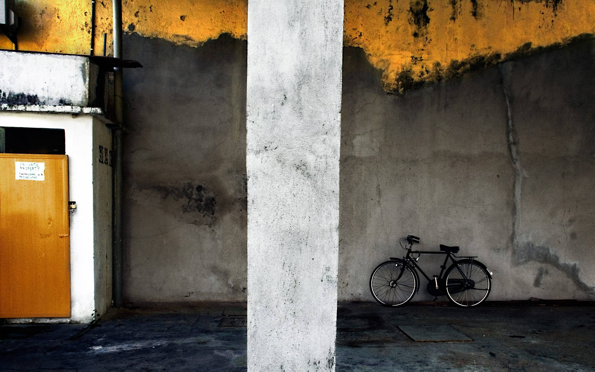 Bicycle In A Bare Building Background