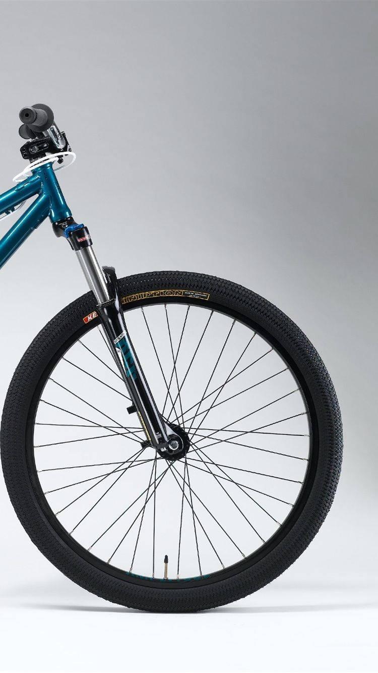 A Blue Mountain Bike Is Shown Against A White Background Wallpaper